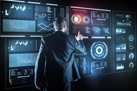 Clever programmer looking calm while touching the transparent screen Stock-Fotos