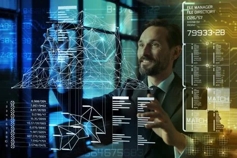 Clever programmer standing in front of his device and touching the screen Stock-Fotos
