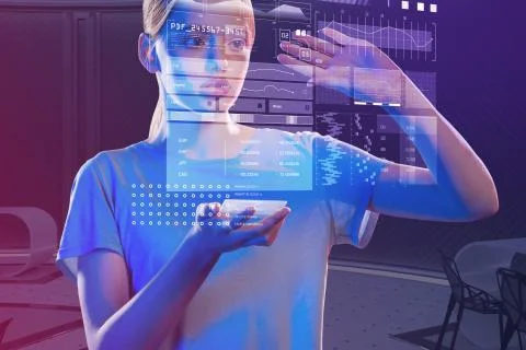 Clever student holding a tiny gadget and making impressive holograms Foto stock