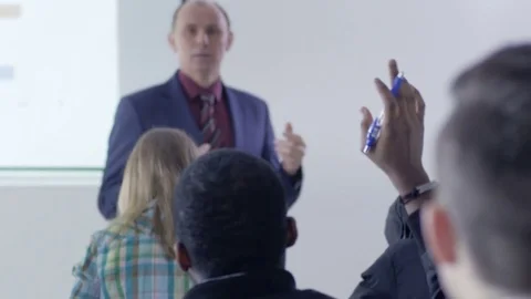 Clever student raising a hand  to ask professor a question in the seminar 스톡 동영상 69931432