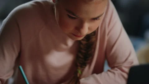 Clever student schooling remotely. Diligent girl doing math homework indoors. Stock Footage 142936581