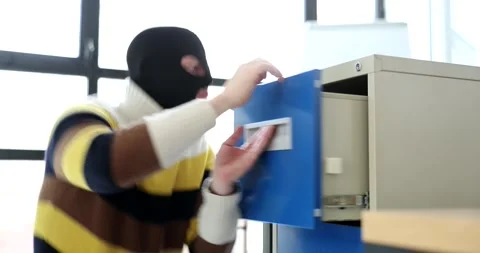 Clever thief in black mask on face unlocks safe with clip Stock Footage 238369865