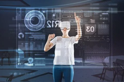 Clever web developer wearing virtual reality glasses and working Stockfoto's