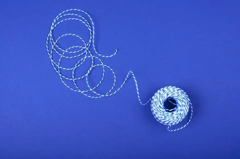 Clew of threads on blue background Stock Photos