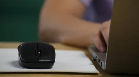 Click black computer mouse on a work desk. Working with a PC or laptop at w.. Stock Photos