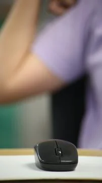 Click black computer mouse on a work desk. Working with a PC or laptop at w.. Stock Photos