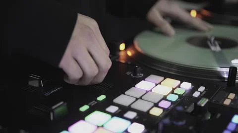 Click colored squares on mixer panel. ART. Hands in dark room are dialing code 库存照片