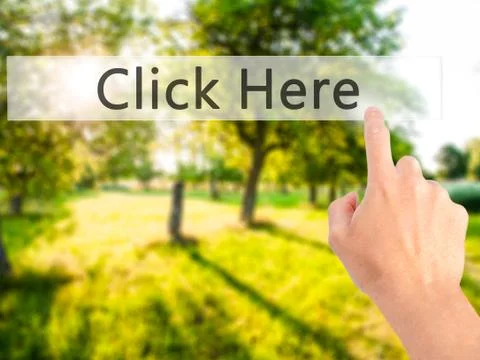 Click Here - Hand pressing a button on blurred background concept on visual s Stock Photos