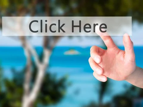 Click Here - Hand pressing a button on blurred background concept on visual s Stock Photos