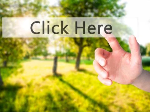 Click Here - Hand pressing a button on blurred background concept on visual s Stock Photos