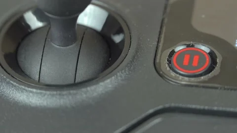 Click the "pause" button on the remote drone. Stock Footage 141855899