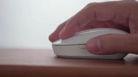 Click white computer mouse on a work desk in dolly shot. Stock Footage 144801136