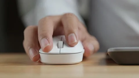 Click white computer mouse on a work desk. Working with a PC or laptop Stock Footage 153945427
