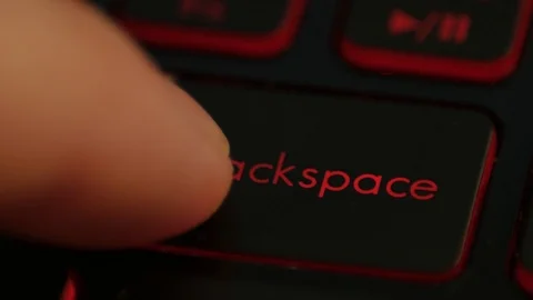 Clicking finger pressing backspace button on keyboard computer Stock Footage 122592448
