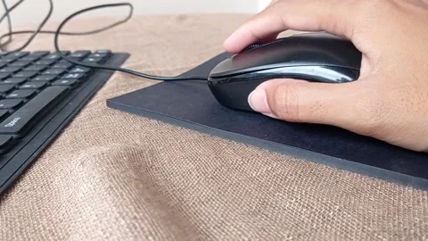 Clicking the mouse on a black pad Stock Footage 146246878