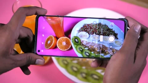 Clicking a photo of assorted breakfast items on a white plate Stock Footage 163335626