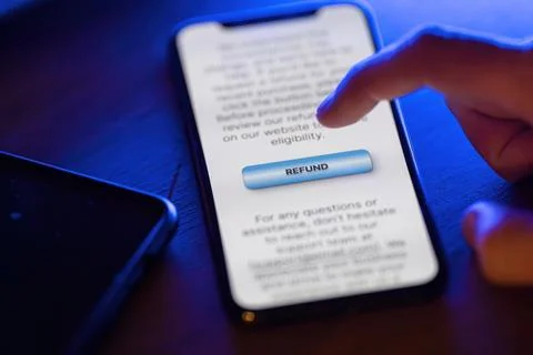 Clicking on refund button on smartphone app Stock Photos