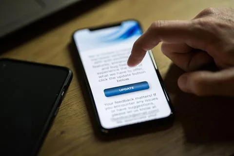 Clicking on update button on smartphone app Stock Photos