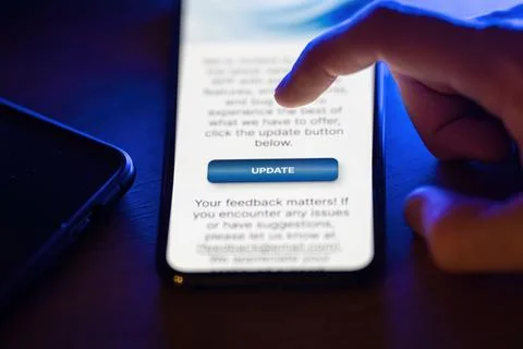 Clicking on update button on smartphone app Stock Photos