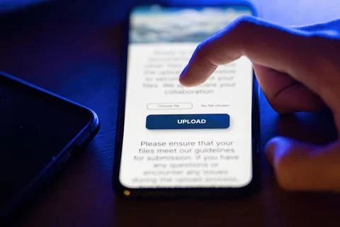 Clicking on upload button on smartphone app Stock Photos