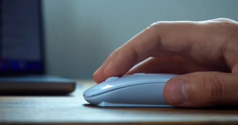 Clicking white computer mouse on a work desk. Human hand holding using mice for Stock Footage 231196036