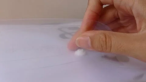 Clickling a white button on a transparent bag Stock Footage 145562959