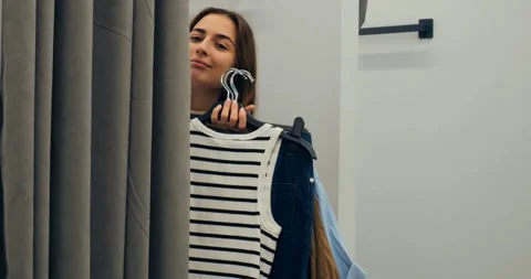 Client analyzing clothing choice in mirror, client reviewing choice coherence Stock Footage 314466004