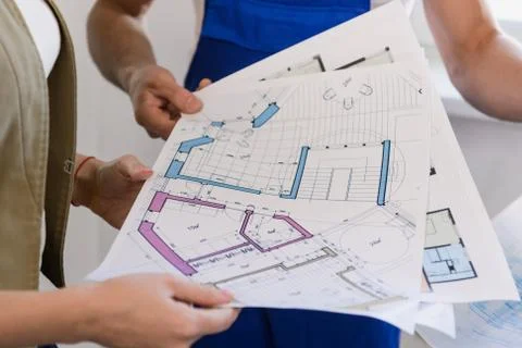 The client and the builders examine the scheme Stock Photos