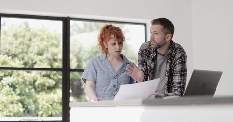 Client and contractor looking at building plans Stock Footage 109507765