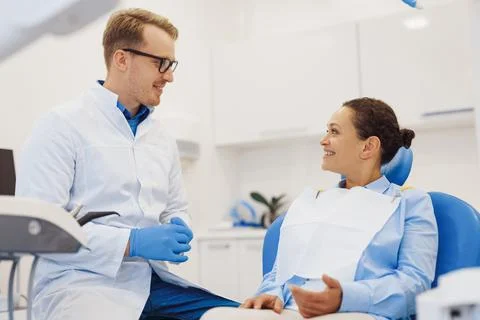 Client and dentist talking about treatment procedure Stock Photos