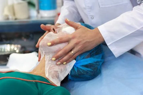 Client and the expert hands during medical cosmetic procedures. Cosmetology Stock Photos