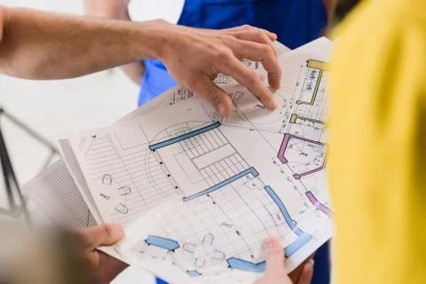 The client and the workers examine the scheme Stock Photos