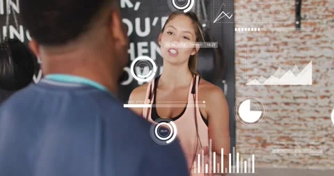 Client answering trainer in gym, showing tips improving form while HUD charts Video stock 329234299