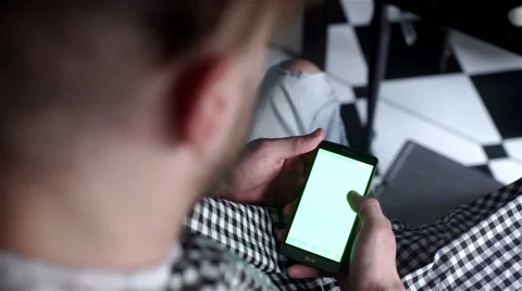 Client in barber shop use  his phone Stock Footage 62948199