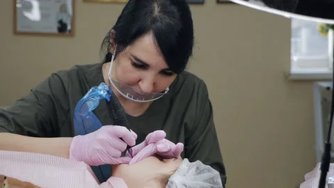 The client of the beauty parlor is lying on the couch. The beautician applies Stock Footage 167034955