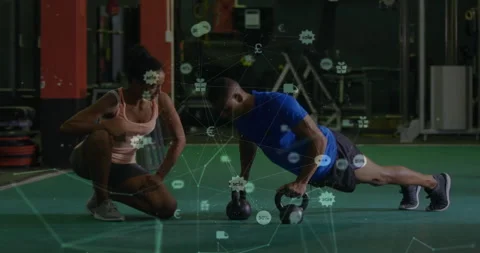 Client doing kettlebell rows for power under coach correcting posture with Stock Footage 313509324