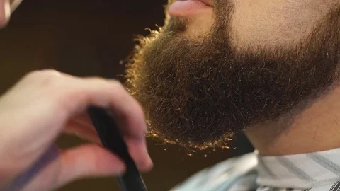 Client during beard and moustache grooming in barber shop Stock Footage 70950905