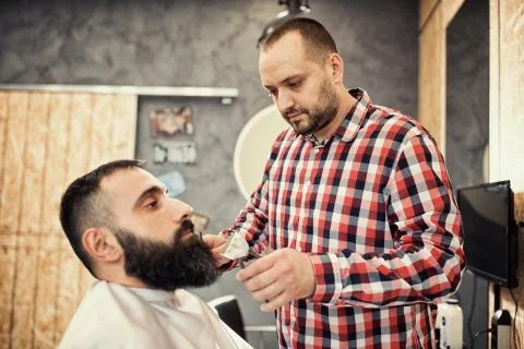 Client during beard and moustache grooming at barber Stock-Fotos