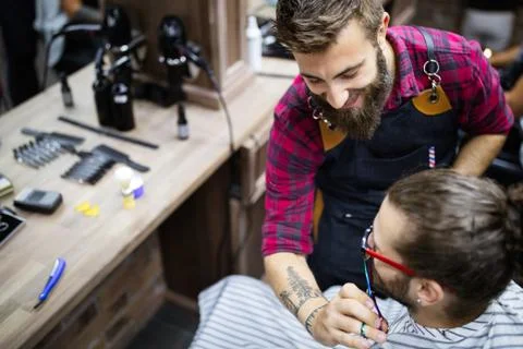 Client during beard and moustache grooming in barber shop Stock Photos