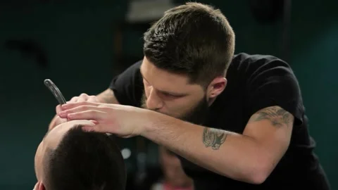 Client during beard grooming in barber shop Stock Footage 311518492