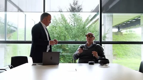 Client Engaging with VR While Businessman Watches in Office Setting Stock Footage 275861071