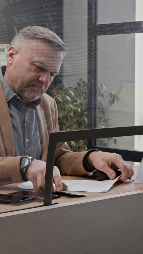 Client Examining Documents While Teller Working Behind Glass Stock Footage 330961131