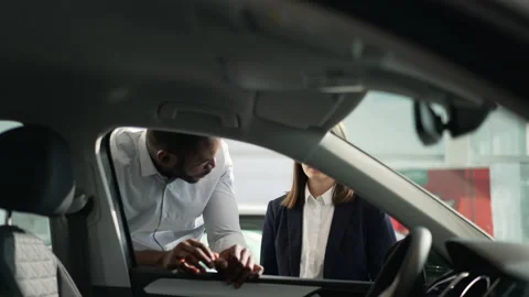 Client is examining interior of car and talking to manager while visiting Stock Footage 182896325