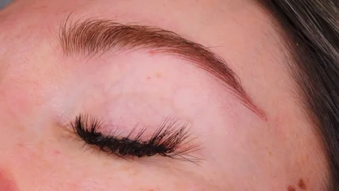 Client with false lashes blinks eyes open after beauty procedure Stock Footage 278317582