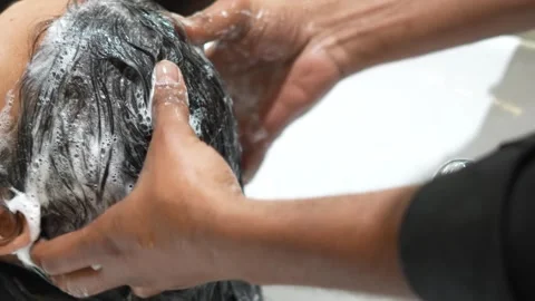Client Getting Head Wash at Shampoo Station  Professional Salon Service Stock Footage 325528784