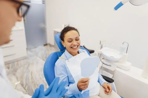 Client looking in the mirror on teeth Stock Photos