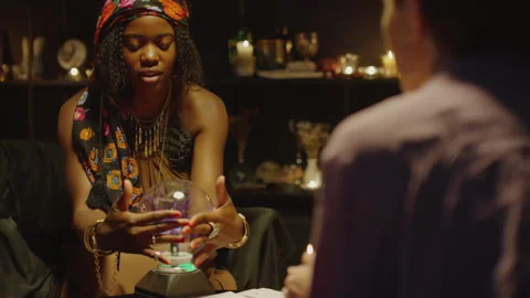 Client Looking at Physic when Fortune Telling on Crystal Ball Stock Footage 247632969