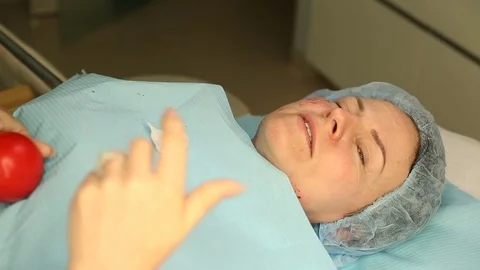 Client looks stressful while talking to someone and holding a toy Stock Footage 76187433