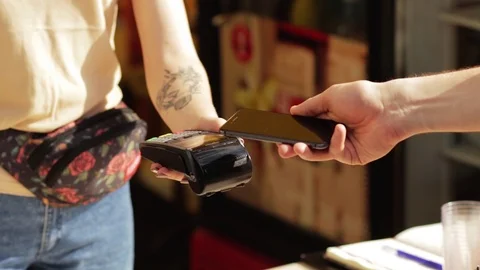 Client making contactless payment with nfc technology credit card at shop Stock Footage 116763229