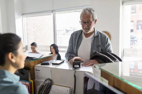 Client making payment with credit card at natural medicine clinic Stock Photos